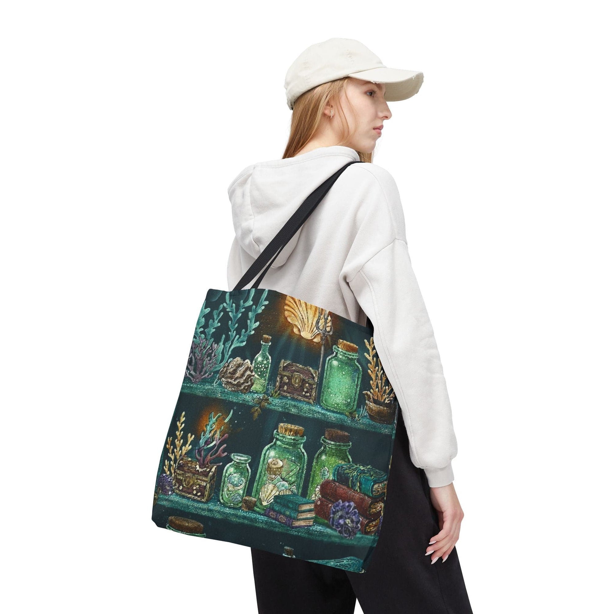This enchanting 18x18 all-over print tote features a glowing undersea bookshelf scene glass potion bottles, coral curiosities, sunken tomes, and a touch of mermaid magic illuminated by golden light. It’s the perfect companion for dreamers, readers, and ocean-souled collectors who find beauty in the mysterious and the mythical.